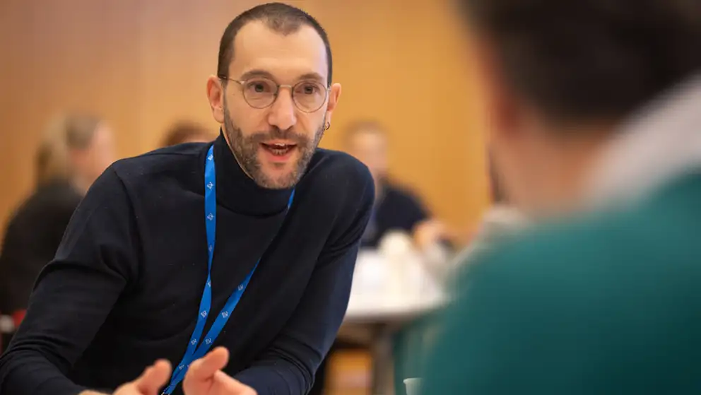 Man explaining something to another man.