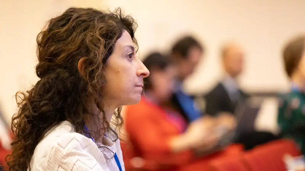 Woman listering to presentation.